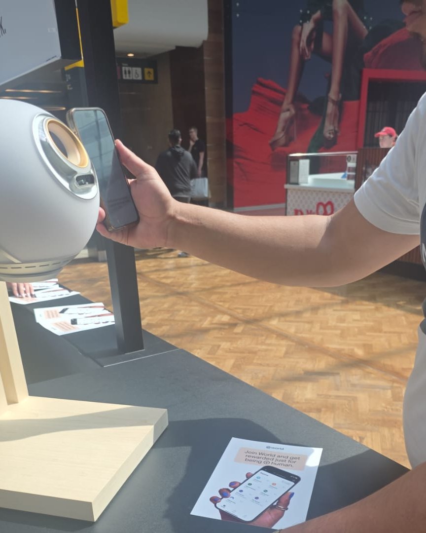 A visitor scans the World ID Orb at the Syncera kiosk in Westfield Stratford City.
